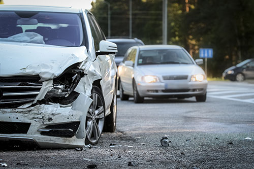 Front of a car damaged by crash accident on the road